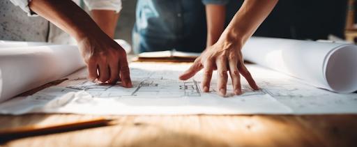 two coworkers reviewing a building plan together